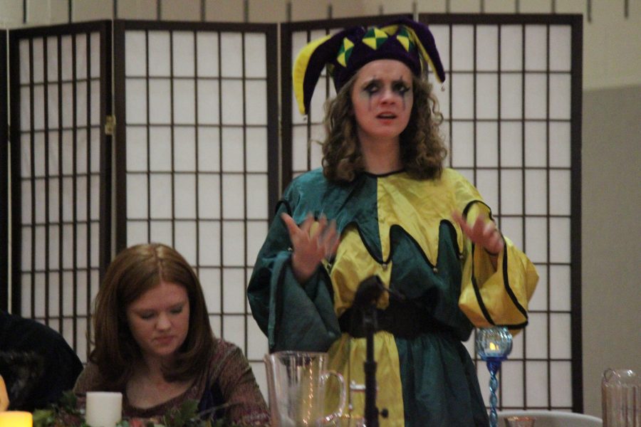 Junior Rachel Lawhead, dressed in traditional jester garb, addresses the audience