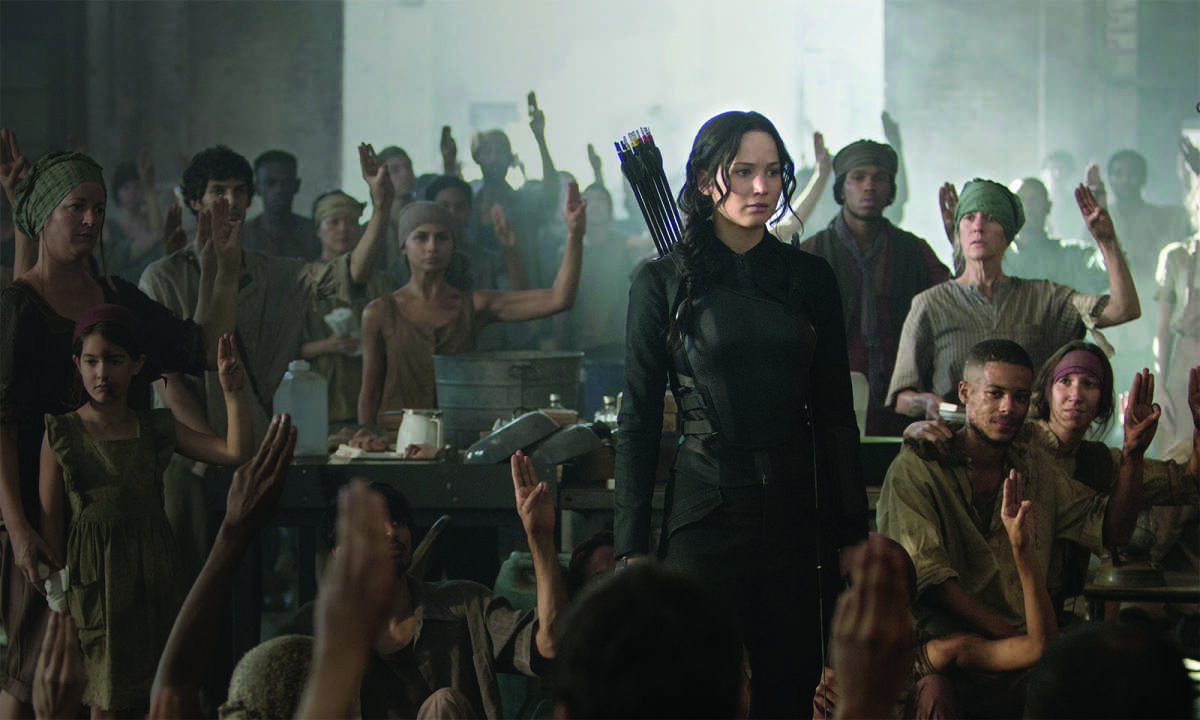 A wounded district- Katniss stands among the district eight war victims, inspiring them.