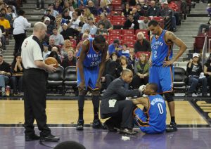 Kevin Durant (left) leans over while Russell Westbrook sits injured on the court. Durant and Westbrook are both MVP candidates, but their lack of team basketball has been their downfall in past years.