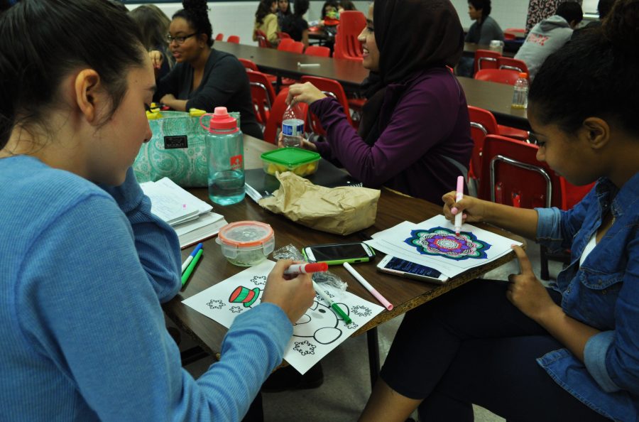 Art is a great way to relieve stress, as these students know, coloring pictures provided by the Active Minds Club for Laugh More, Stress Less week.