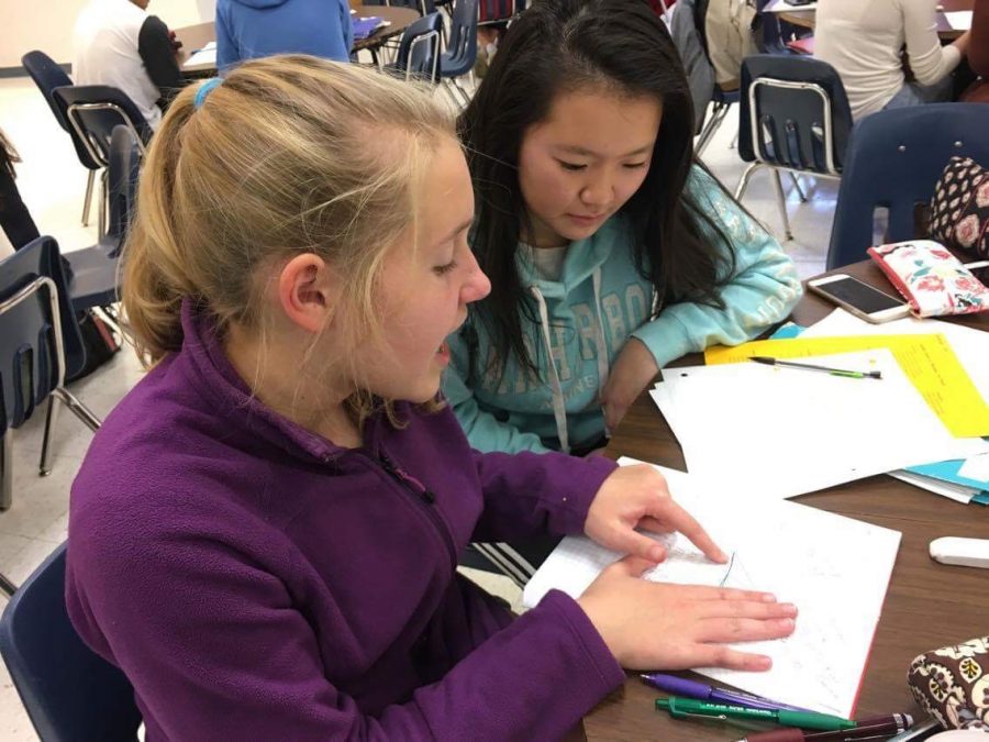 One-on-one tutoring — Freshman Miranda Ma receives tutoring from fellow freshman Katherine Walker. (Photo courtesy of Philena Sun)