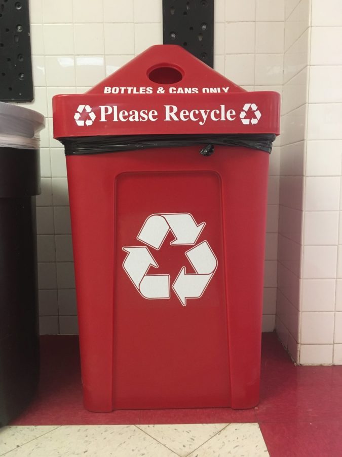 One of the new red recycling bins located next to the rock entrance