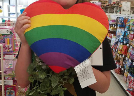 A McLean sophomore holds a rainbow heart in honor of pride month. (Photo by Marguerite Godwin)