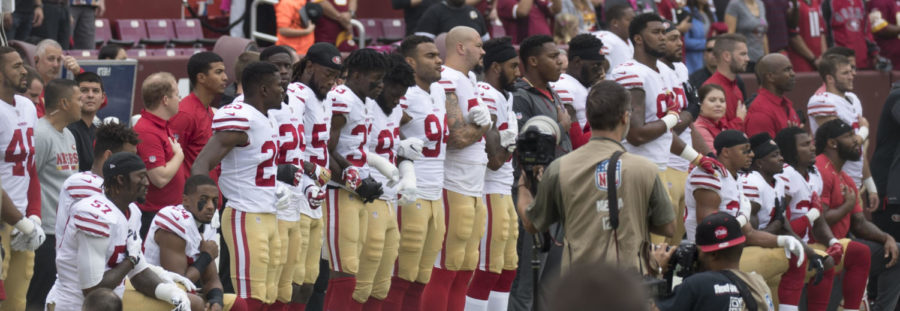 Members of the San Francisco 49ers kneel during the national anthem before a game against the Washington Redskins at FedEx Field on Oct. 15, 2017, in Landover, Maryland.