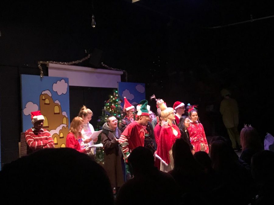 The cast of the Grinch come together on stage to sing a song together.