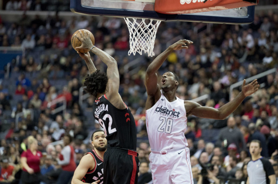 The Wizards have many difficult games in their schedule this year, and one matchup many are awaiting is when thery will play against the  Raptors. Pictured above is an attempted block by Ian Mahinmi on Raptors player Lucas Nogueiras dunk when they played on the 2nd of April, 2018. Photo via Flickr