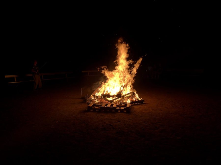 Getting toasty- The softball fields home plate is up in flames as students celebrate Homecoming week. (Photo by Maria McHugo)