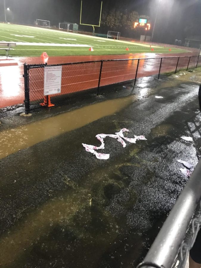 Fans left the Highlander logo on the wet blacktop next to the field. It was assembled using free game-distributed towels thrown into the stands. 