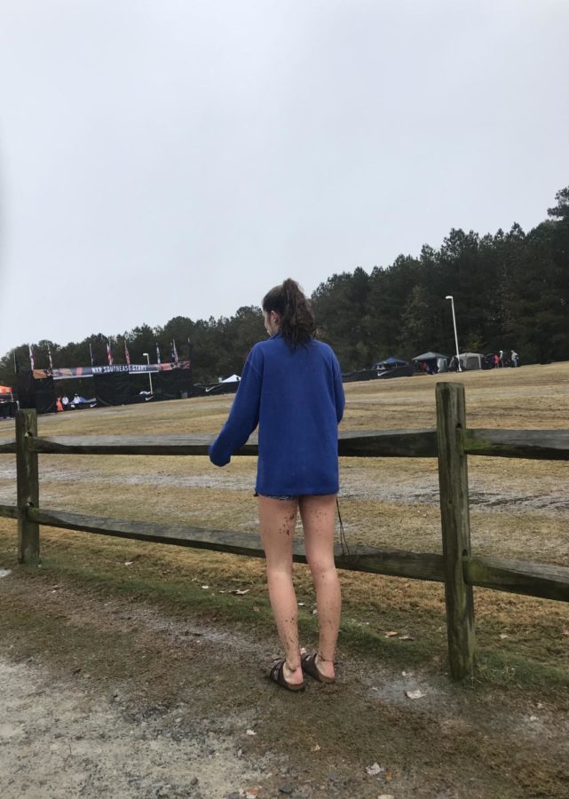 Dancing in the rain--Senior Caroline Howley flashes her muddied legs to the camera after her race on Nov. 24 in Cary, NC. (Photo courtesy of Clarissa Cullers)