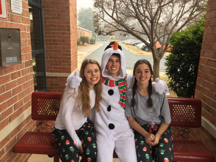 Sophomore Skye Sunderhauf (left), junior Zach Anderson (middle), and sophomore Katie Romhilt (right) show off their school spirit. They dressed up for comfy clothes day two days before the start of winter break. (Photo by Emily Jackson)