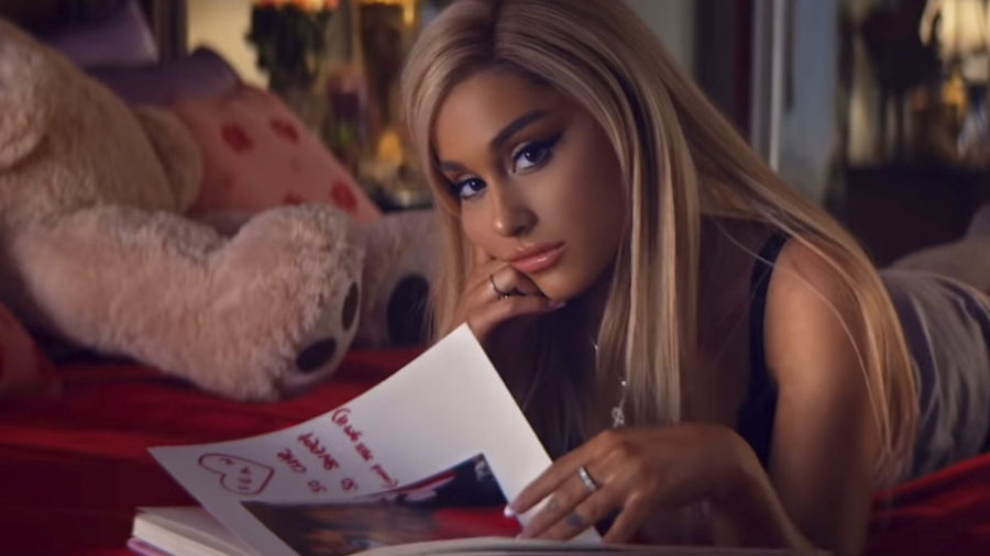 Ariana Grande as Regina George reading her own Burn Book (Photo via Republic Records)