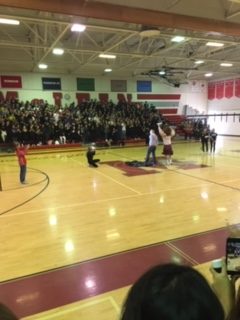 Teacher Tony Puzan gets pied in the face by our mascot Angus at the pep rally on Friday, Jan. 11. This was result of a money raising competition between teachers run by McDance-a-thon.