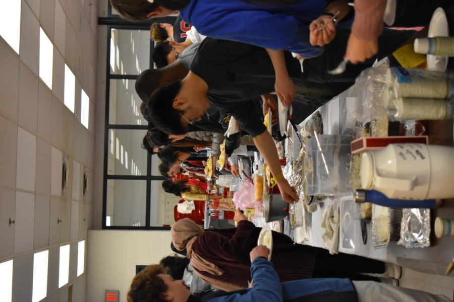 Hungry students dig in to experience a variety of foods around the world.