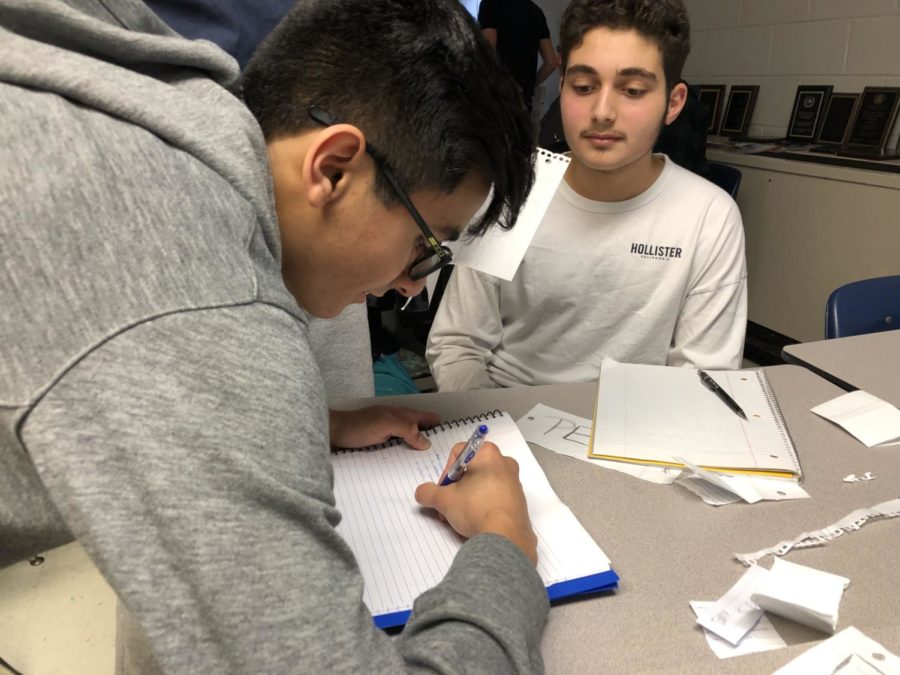 sophomores Peter Awabdeh and Zayan Baig work on their speeches during the mock conference held on Feb. 11. 