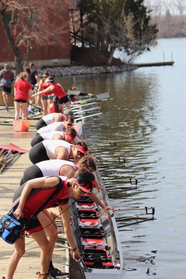 Here the Men's 1V, the team's fastest boat, is getting lowered into the water. They would later place second in their respective bracket. 