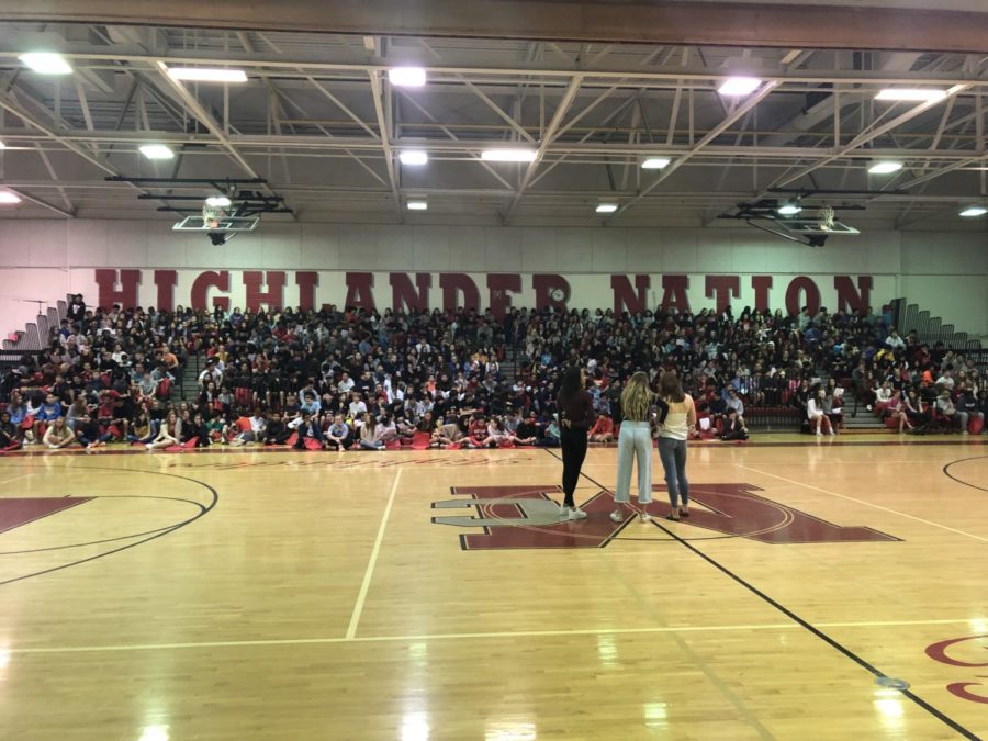 Students from Longfelllow sit on the bleachers being infromed by McLean students about the various sports and clubs the school provides 