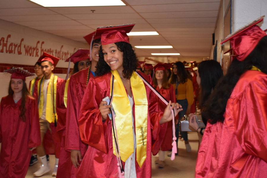 Honor student Riley Carr poses for a shot of her final walk down the schools halls. 