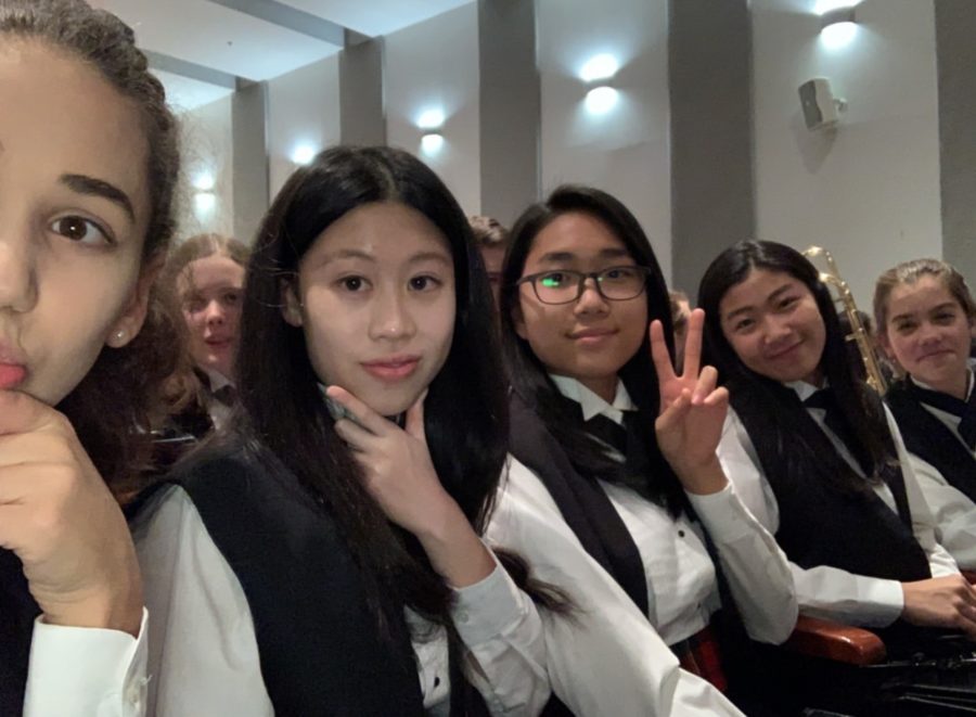 Freshman Nicole Chan (second from the right) is seen here posing for a picture with her friends. This was during a band concert while they were waiting for their performance. 