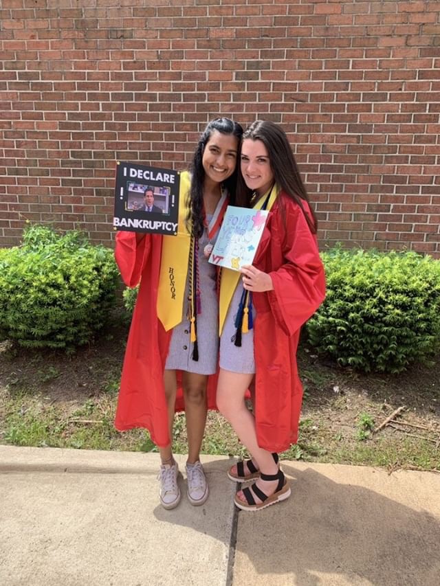 Seniors Aarushi Desai and Ellie Schultz pose with their decorated graduation caps.