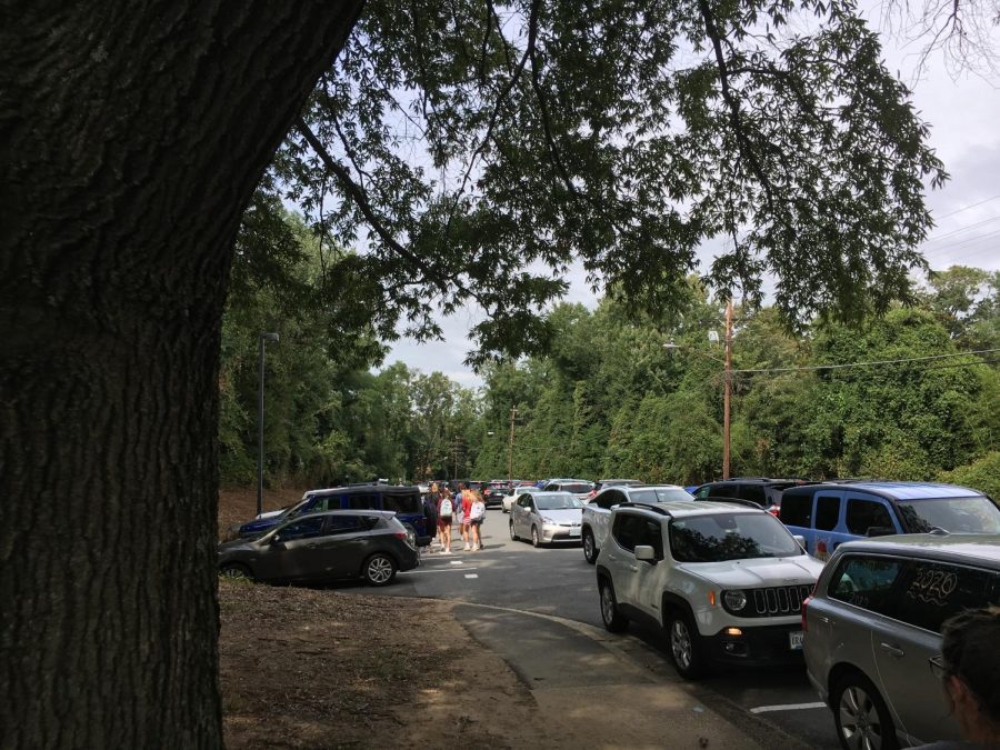 Rush Hour--Students try to drive home in the gridlock that has infiltrated this two-way street. Cars in the new parking spaces are blocked by the long line of vehicles behind them.