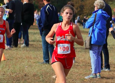 Senior Elly Glenn pushes through the final stretch of the course. Although sick, her efforts helped the varsity girls place third.