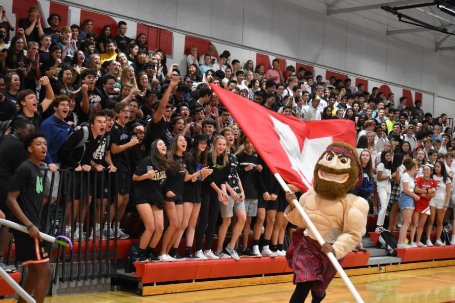 SECTION SCREAMS- Angus runs around the gym with our flag as the grades compete to be the loudest