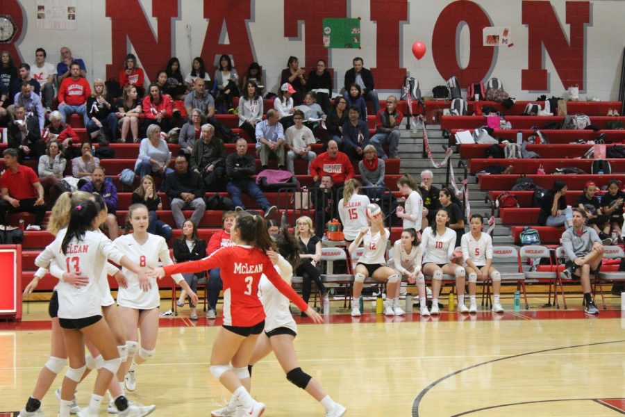 The McLean volleyball players on the court run together after scoring a point. This game against Washington-Lee occurred on Oct. 17. 