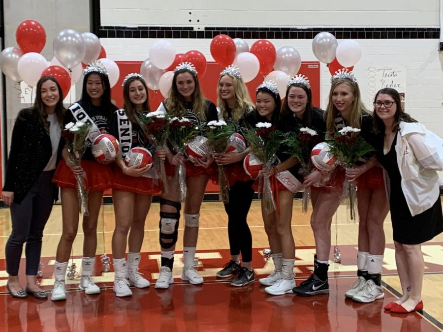 The+seniors+line+up+with+the+varsity+coaches+after+entering+the+gym+with+their+families+and+receiving+their+flowers.+%28Photo+by%3A+Emily+Friedman%29