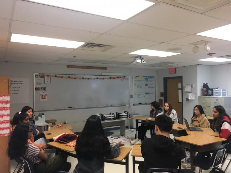 The group engages in a discussion about various humanitarian crises 