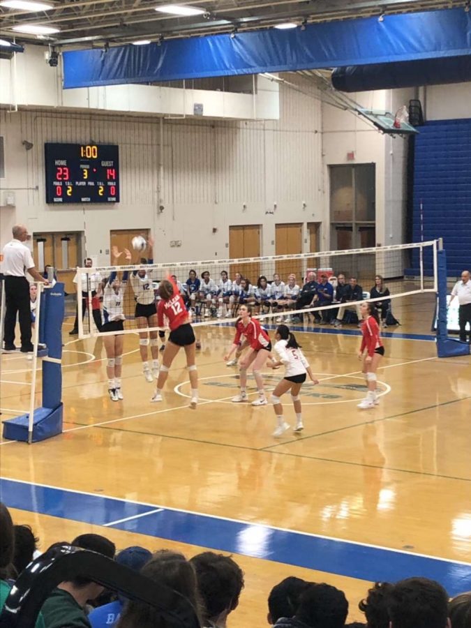CLOSE ONE - Nicole Mallus hits the ball over the net, scoring a point for the McLean Highlanders. This point brought the Highlanders closer to winning.