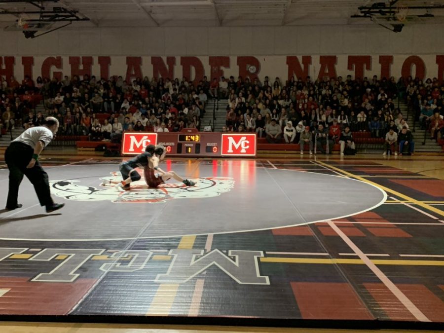 A+McLean+wrestler+attempts+to+escape+a+take+down.+McLean+was+able+to+score+off+their+take+downs+throughout+the+night.+%28Photo+obtained+via+McLean+Athletics+Twitter%29