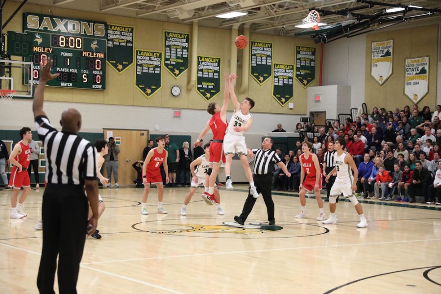 Player Aaron Bremser attempts to get control of the ball at tip-off. 