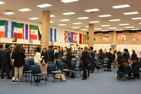 MUN Greetings— Delegates of the Organization of American States (OAS) committee greet each other before committee begins. They discuss ideas about the Venezuelan crisis.