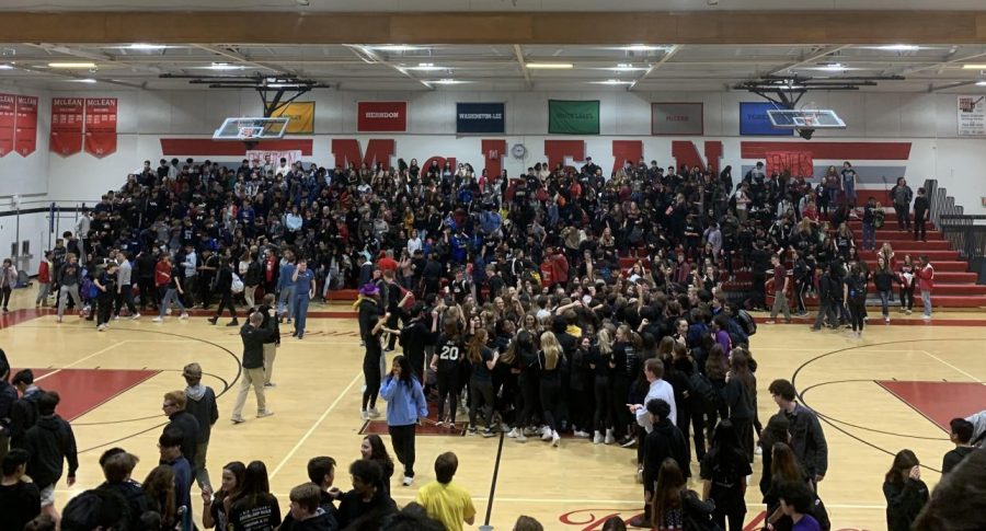 The crowd jumps to the music in the center of the gym when the pep rally ends.