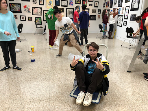 Art students pose for a picture at the art show set up. The show will take place on Thursday. 