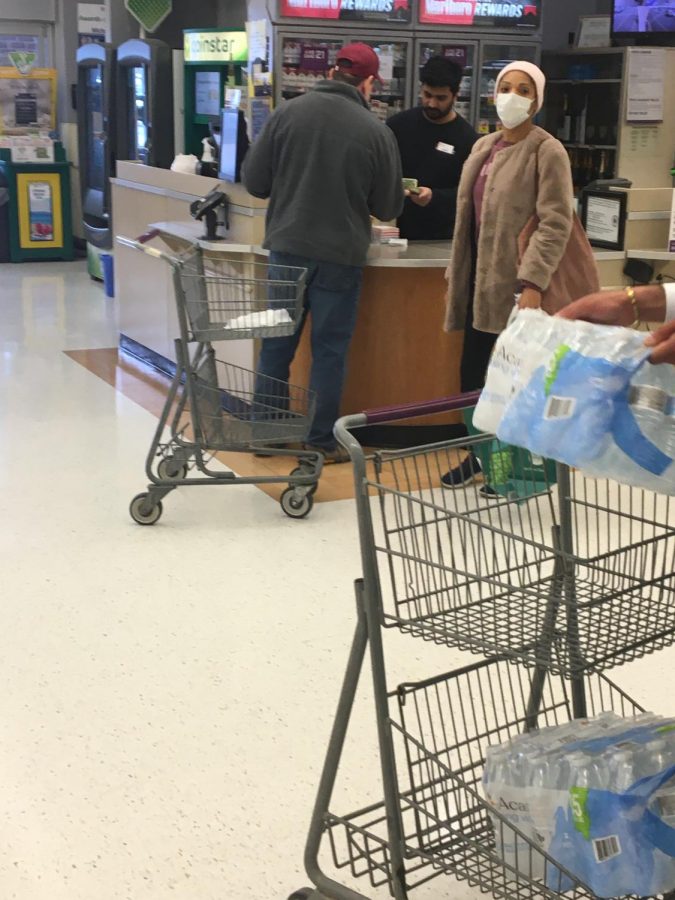 The McLean local Giant was packed this weekend with cautious customers preparing for the worst. This masked shopper was waiting for help from customer service.