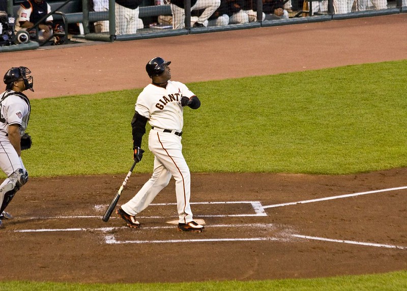 Barry Bonds swings, delivering one into the seats. Although he hit a record setting 762 home runs, his steroid use strips him of this title. (Photo obtained under fair use via Creative Commons license).