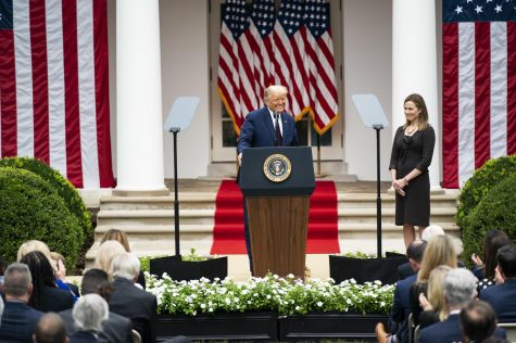 Barrett stands by as Trump introduces her as his nominee for Supreme Court Justice in a Rose Garden White House ceremony. It is still unconfirmed whether this selection will stand with the upcoming election. (Image obtained via The White House on Flickr under a Creative Commons license.)