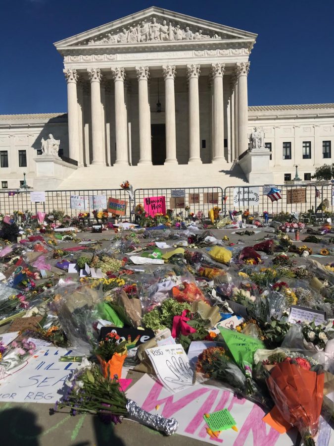 People+place+flowers+and+cards+in+front+of+the+Supreme+Court+to+show+their+support+for+the+late+Justice+Ruth+Bader+Ginsburg.+The+Supreme+Court+was+closed+off+due+to+COVID-19%2C+so+people+left+the+gifts+around+the+gate.