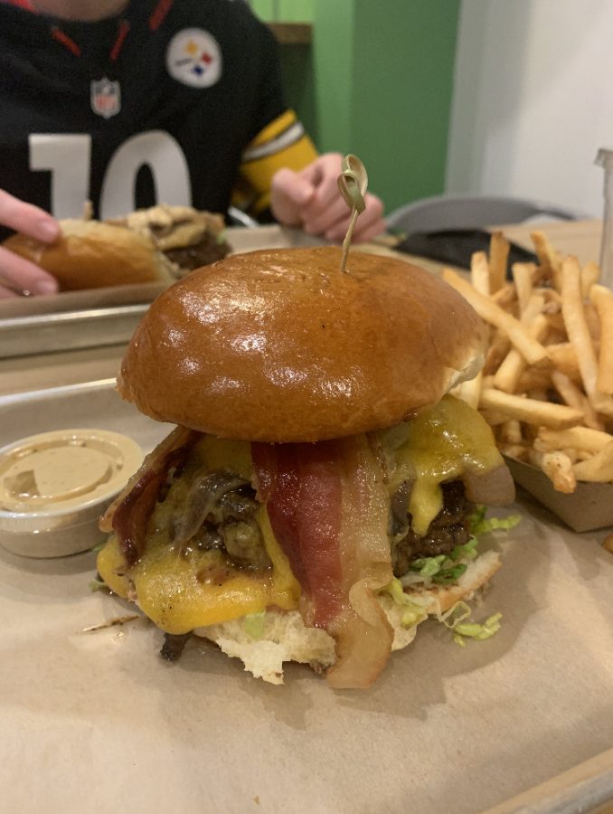 Here+stands+the+monstrous+Anniversary+Burger.+Loaded+with+angus+beef%2C+extra+sharp+cheddar%2C+bacon%2C+lettuce%2C+and+grain+mustard+aioli%2C+this+delicious+burger+will+always+stand+out+in+a+crowd.