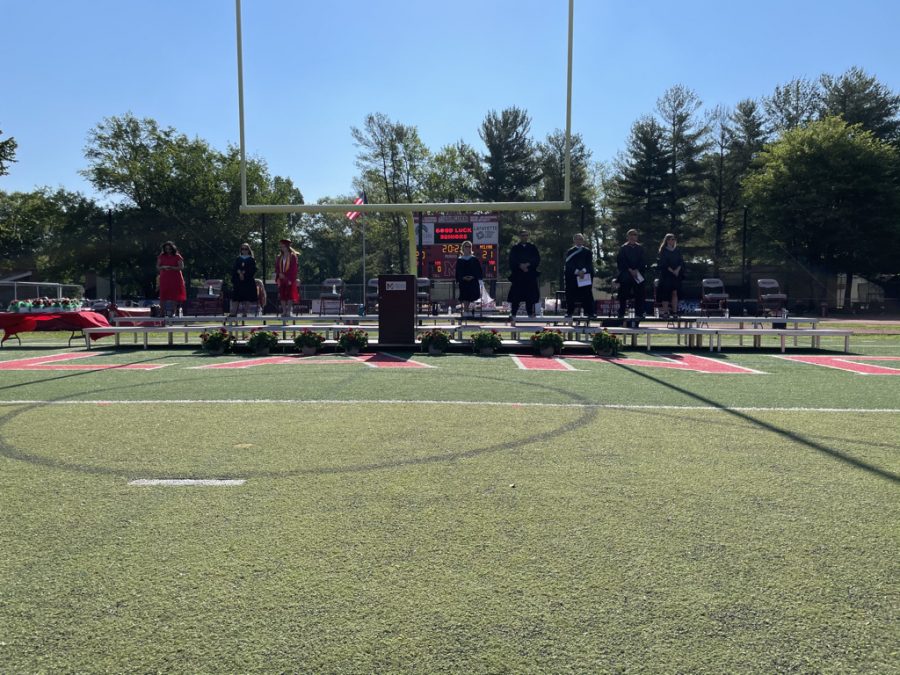McLean staff and educators sat alongside the Senior Class Council on a makeshift stage on McLeans field endzone. They faced an audience of 500 seniors to celebrate their achievements. Photo taken by Kyle Hawley.   