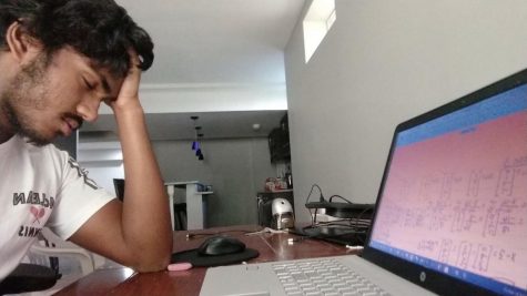 Junior Varun Veluri struggles to focus on his math classwork while at home. The abundance of distractions at home makes it harder for students to be engaged during class.