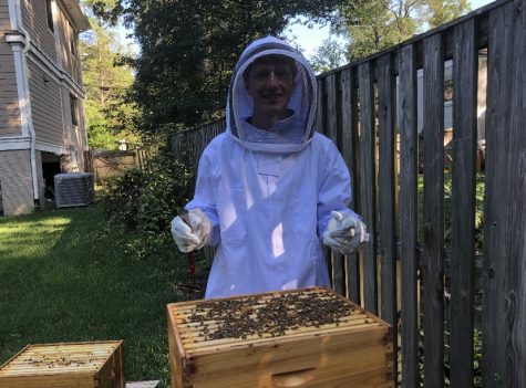 Jordan Coopersmith cares for his bees. He wears a suit to protect himself, as well as smoke to calm the bees.