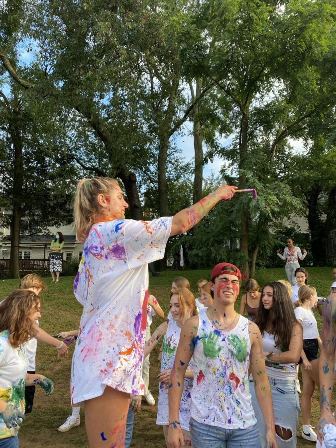 IN+THE+ACT-+Senior+Monica+Molnar+splatters+paint+at+celebrate+McLean.+The+seniors+in+leadership+stood+above+other+students+and+threw+paint+on+them.