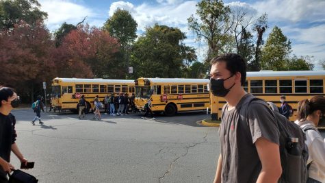 Students line up near on-time buses at the end of the school day. Late buses will fill the remaining spots on the swaths of empty pavement as they arrive.