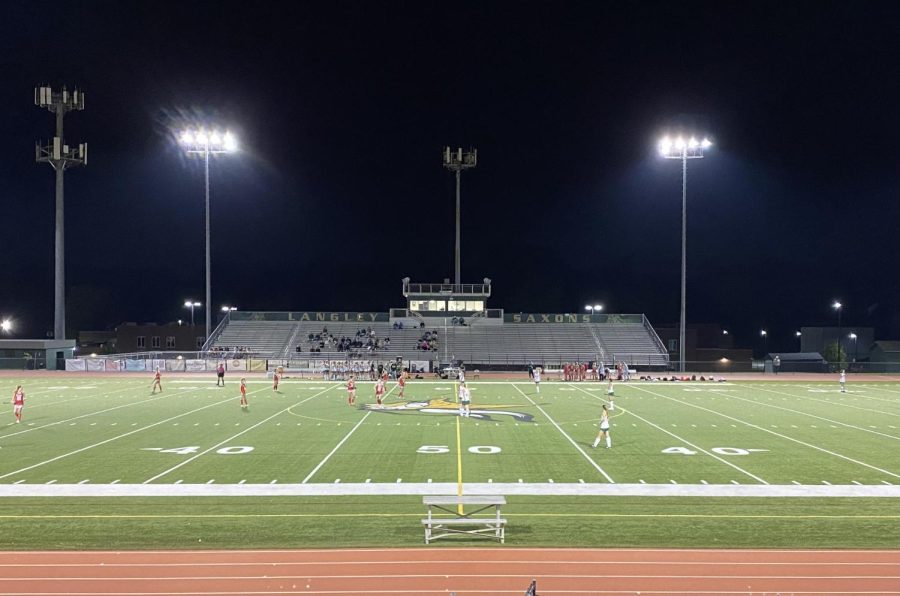 Players line up on the field before starting the second half of the game.