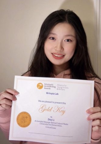 Junior Zhiyi (Zoe) Li poses with her certificate after winning Gold Key in the Regional Writing Awards of the Scholastic Art and Writing Awards. 