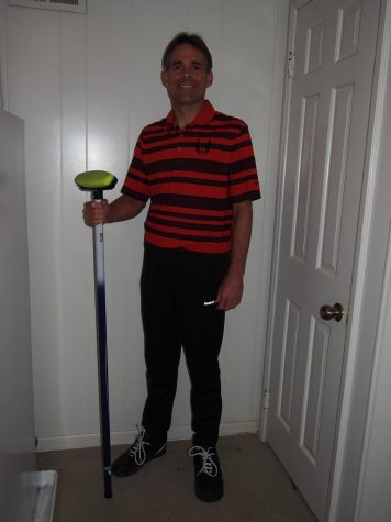 Oceanography teacher Andrew Diller poses for the camera with his curling stick