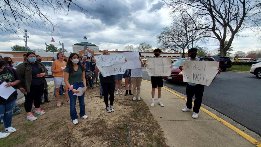 Demonstrators at Mclean High School, including leader Saehee Perez, protested against then-candidate for Superintendent Michelle Reid. Students in the photo are facing The Highlander and the McLean Connection for photographs to gain press and public attention.