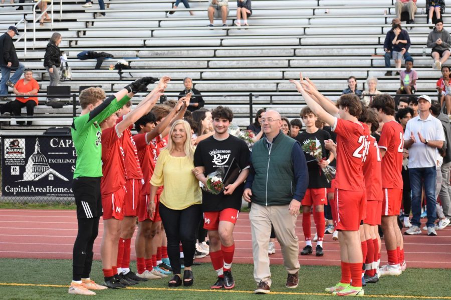 Each senior soccer player walked out onto the field celebrating their senior night with  family and friends. 